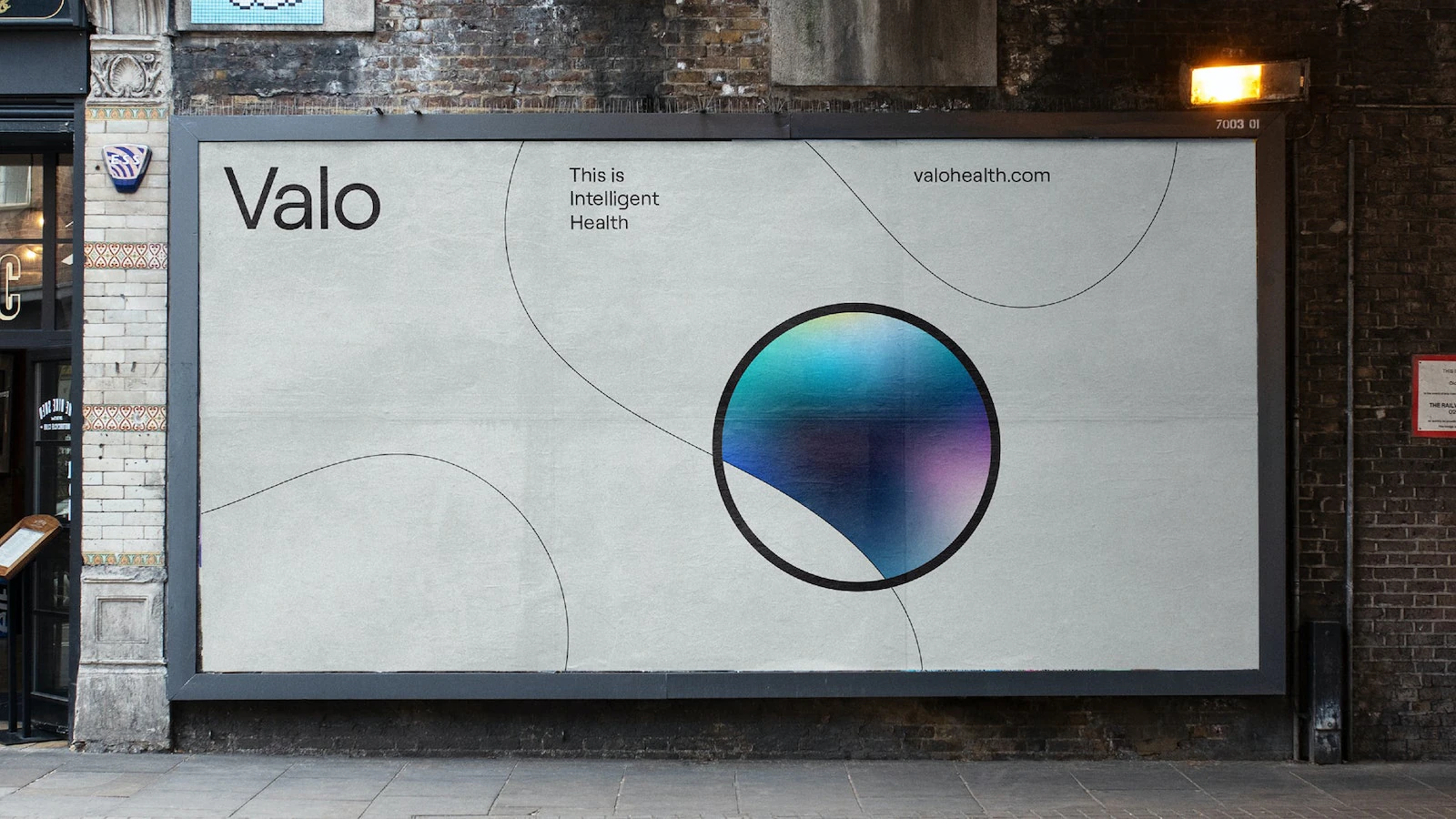 Valo Health's logo displayed on a screen in an office